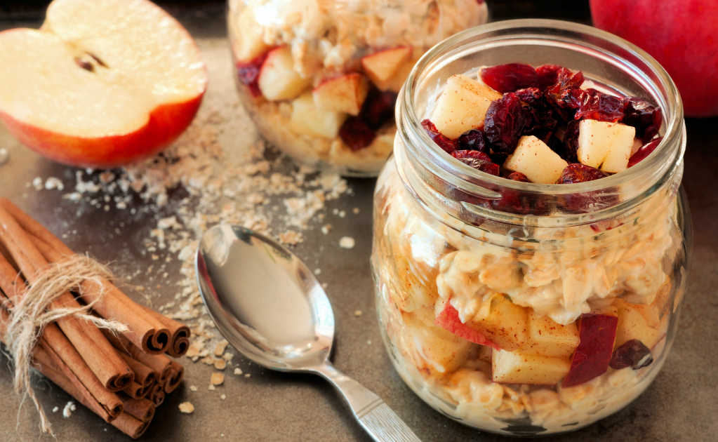 Autumn overnight oats with apples and cranberries in a mason jar